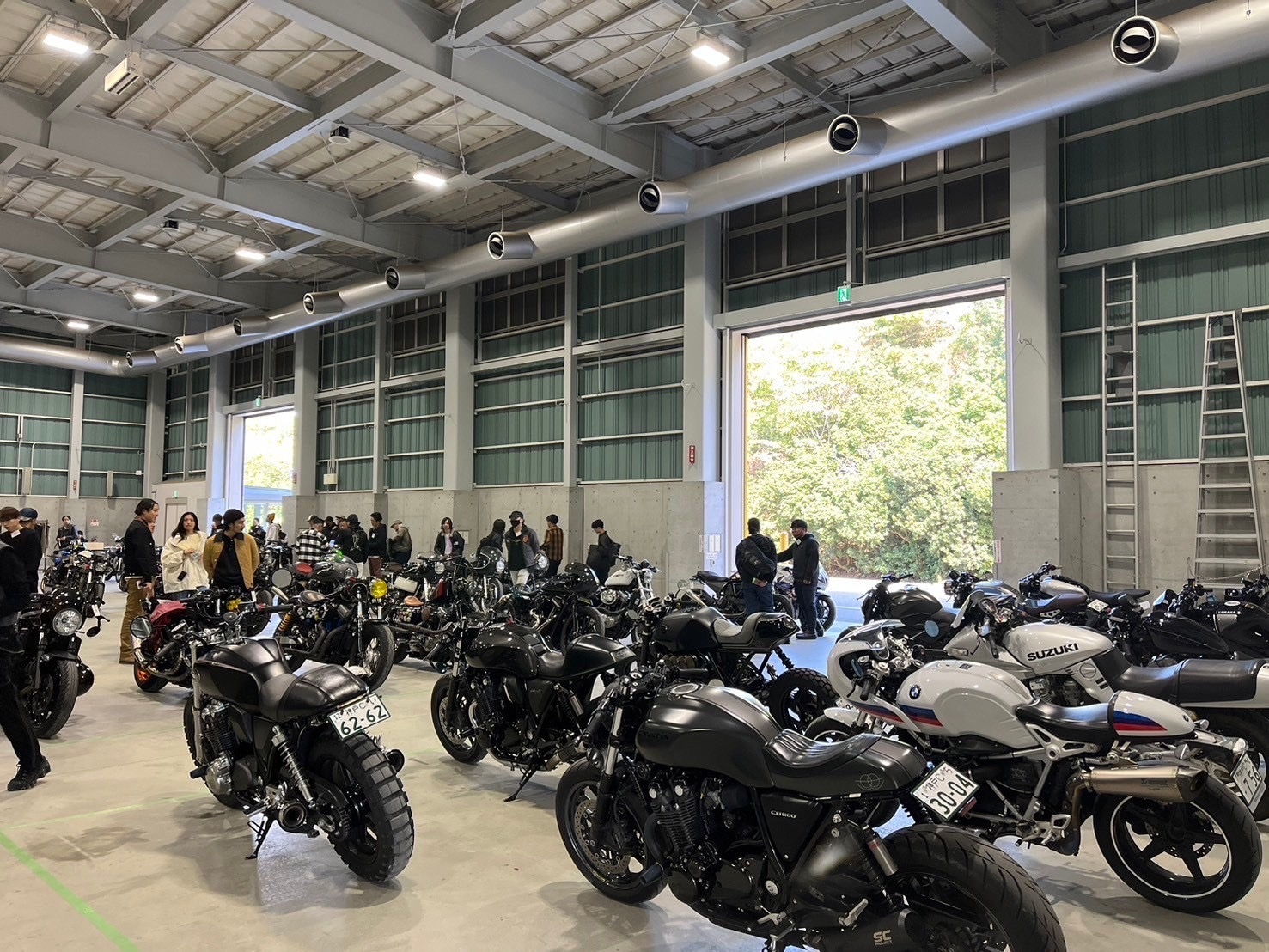 会場内に並ぶカスタムバイクと、それを眺める参加者たち